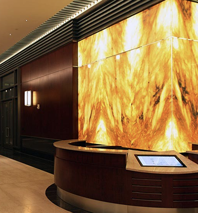 Backlit honey onyx feature wall in a reception area
